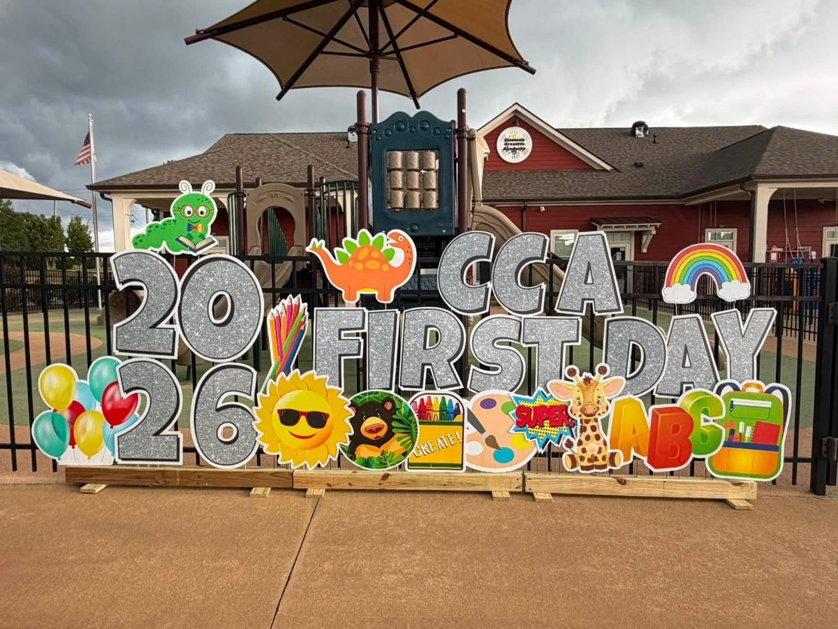 First Day 2026 display at a school with crayons, rainbow and dinosaur cutouts